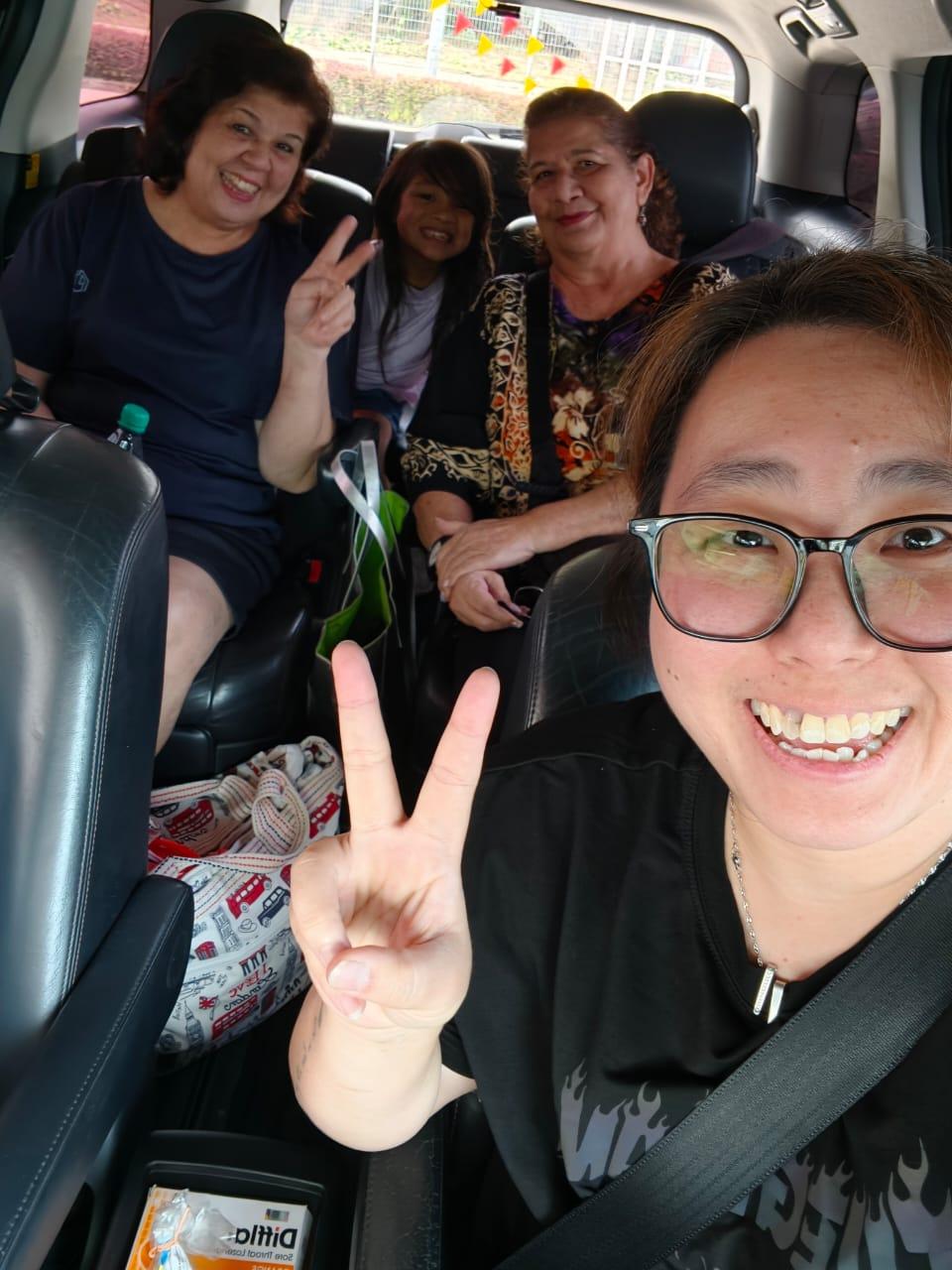 Real customer family group inside a private MPV ride